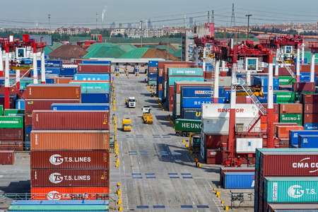 QINGDAO, CHINA - May 15, 2017: Qianwan container terminal with city skyline in the background at...