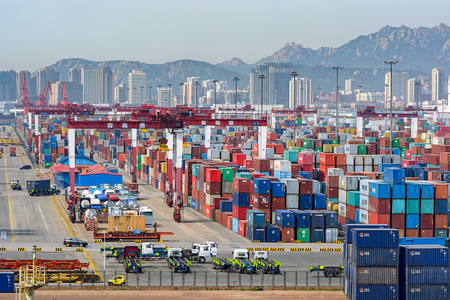 QINGDAO, CHINA - May 15, 2017: Qianwan container terminal with city skyline in the background at Qingdao.のeditorial素材