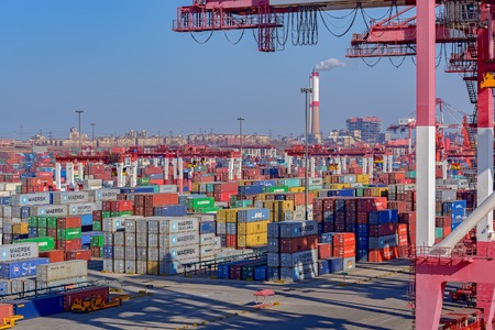 QINGDAO, CHINA - Jan 20, 2017: Shipping containers are stacked at the Qingdao Qianwan Container Terminal.のeditorial素材
