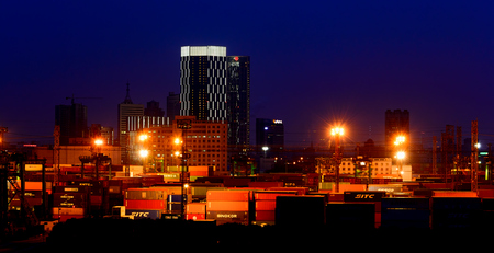 SHANGHAI, CHINA - Jan 24, 2017: Night view of container terminal with city skyline in the background...