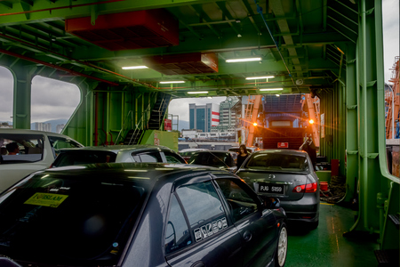 PENANG, MALAYSIA - Jan 02, 2017: Vehicles, their passengers and pedestrians onboard a cruising Penang Ferry service between mainland and Penang island.のeditorial素材
