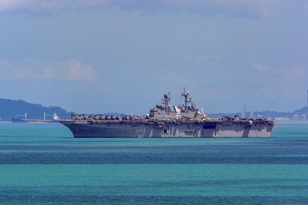 SINGAPORE STRAIT, SINGAPORE - Dec 22, 2017: the first of the America-class amphibious assault ships USS America (LHA 6) approaches to Changi Naval Base during a regularly scheduled port visit.のeditorial素材