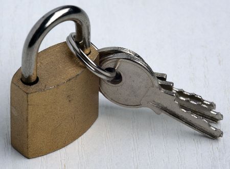 padlock with three keys. keys are attached to the padlock with the ringの写真素材