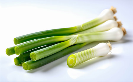 Fresh spring onions on a white background. Shallow depth of field.の素材