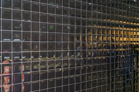 Shiny wall of black convex square tiles with polished reflective surfaceの写真素材