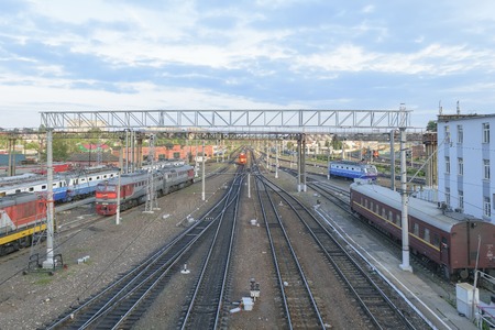 Major train station. Rails stretching into the distance. Flaw detector car is on the tracks near the building. Blue sky with a few cloudsのeditorial素材