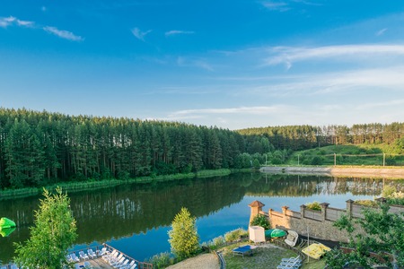 Resting place on the beach on the shores of an artificial lake near the edge of the forestの写真素材
