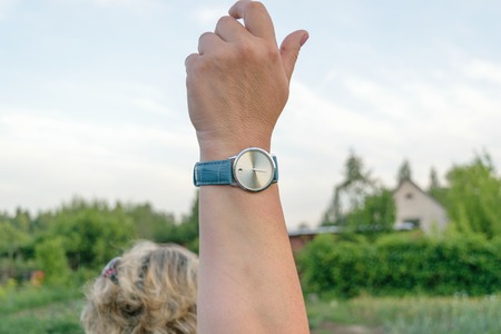The clock on the female hand raised vertically.