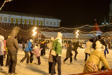 Moscow, Russia - January 05, 2016: People skate on GUM skating rink on Red Square at night