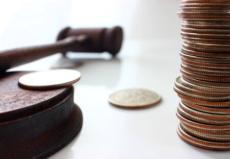 Hammer of a judge on a heap of dolor coins, a legal rightの写真素材