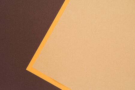 Abstract background from recycled textured paper forming triangular shades of dark brown and yellowの写真素材