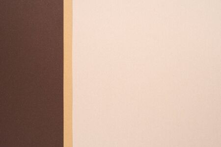 Abstract background from recycled textured paper forming vertical shades of dark brownの写真素材