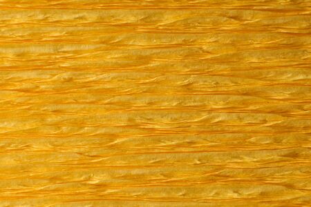 Yellow wrinkled crepe paper close-up detail. Front viewの写真素材