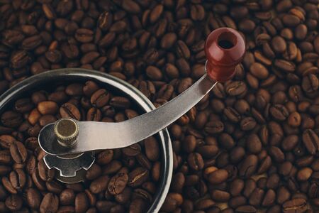 Vintage coffee grinder steeped in roasted arabica coffee beansの写真素材