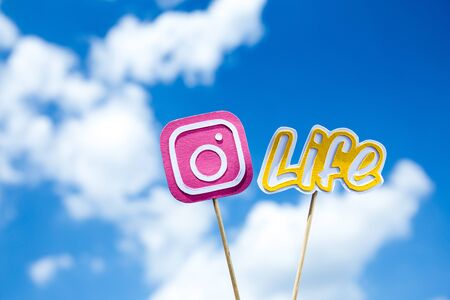 KYIV, UKRAINE - MAY 25, 2019: paper cut Instagram icon and life word on sticks on blue sky backgroundのeditorial素材