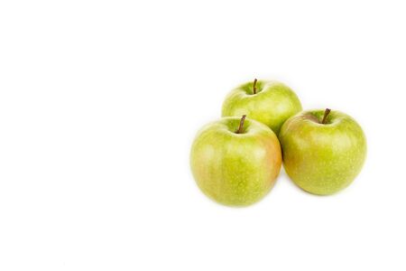 green ripe fresh apples isolated on whiteの写真素材