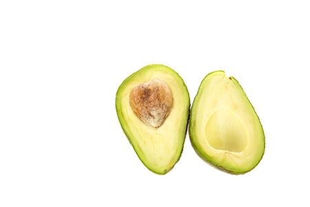 top view of delicious ripe cut avocado with seed isolated on white
