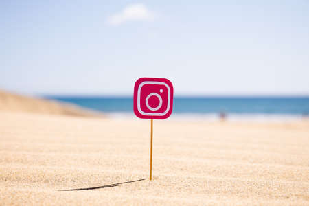 MASPALOMAS, GRAN CANARIA - OCTOBER, 2019: Instagram icon on stick on sandy beach at sunny dayのeditorial素材