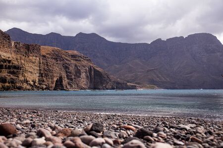 coastline with pebbles, Atlantic ocean and rocks in Agaete, Las Palmasの写真素材