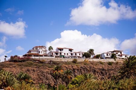 scenic view of buildings and palm trees on mountain in Agaete, Las Palmasの写真素材