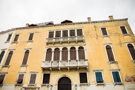 low angle view of ancient building against cloudy sky in Venice, Italy.の写真素材