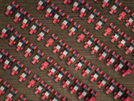 Red tractors on farmland. Aerial top down shot.の写真素材