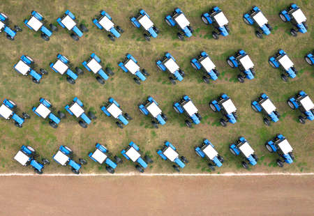 Blue tractors on farmland. Aerial top down shot. Russia.の写真素材