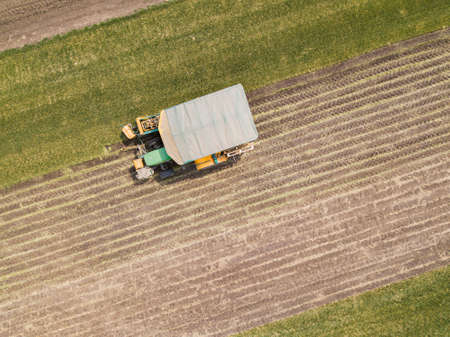 Aerial Drone Photo of Farmer Harvesting lawn rolls. Russia.
