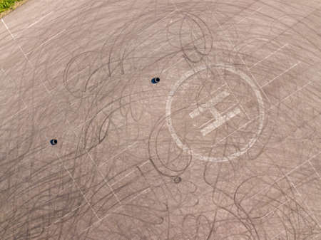 Aerial top down drone shot. Parking with tire tracks. Drifting location.の写真素材