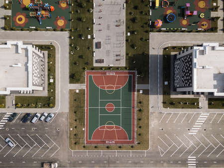 Aerial top down drone shot. Sport ground among the apartment complex.