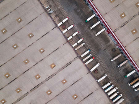 4k Aerial shot of trucks on warehouse parking terminal.の写真素材