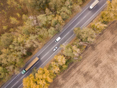 Road through the forest, Aerial view car truck drive going through forest, Aerial top view forest,...