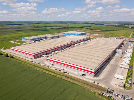 Aerial view of the large logistics park with warehouse, loading hub with many semi-trailers trucks standing at the ramps for load unload goods. Rostov-on-Don.の写真素材
