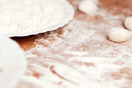 Dumplings and parsley - russian pelmeni. Cook dumplings. Pasta ravioli over wooden deskの写真素材