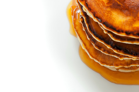 Pancakes with honey on white background