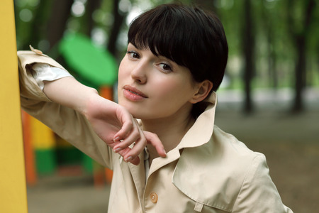 young and beautiful woman on the playground in the parkの写真素材