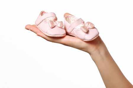 little pink shoes for girls in beautiful female handsの写真素材