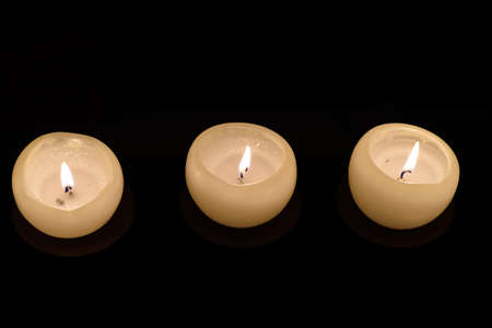 three candles in the darkの写真素材