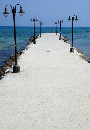 Lonely woman at Aegean Sea coast in Paraliaの写真素材