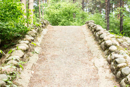 The hill is made of stones. A small hill is created from collected stones. City Park.の写真素材