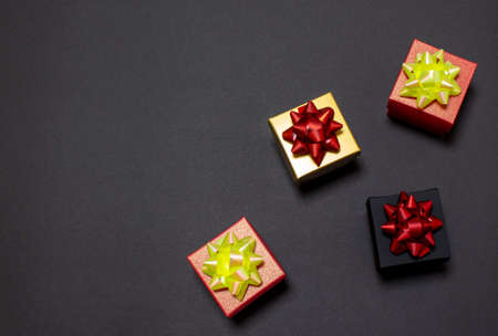 Black Friday sale. Stylish gift boxes lie on a black background. Flat lay, top view, copy space,...
