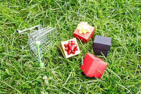 Boxes with purchases and gifts lie next to the supermarket trolley. Holiday concept, sale.の写真素材