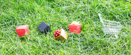 Boxes with purchases and gifts lie next to the supermarket trolley. Holiday concept, sale.の写真素材