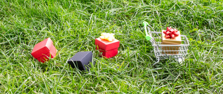 Boxes with purchases and gifts lie next to the supermarket trolley. Holiday concept, sale.の写真素材
