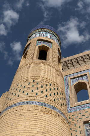 Brick tower with majolica tiles with oriental pattern at gates of old city of Khiva, Uzbekistanの写真素材