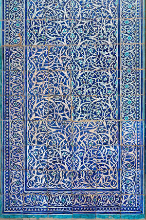 Beautiful intricate pattern in oriental style on tile of ancient wall in old city, Khiva, Uzbekistanの写真素材
