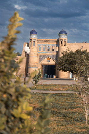 Cityscape with Polvon darvoza gates to Ichan-Kala old city against cloudy sky, Khiva, Uzbekistanの写真素材