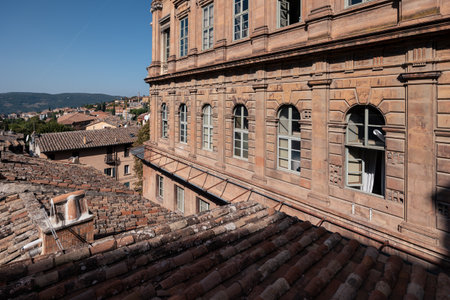 Medieval Italian town with brick houses and tiled roofs and distant hills at sunny day, Perugia, Italyの写真素材