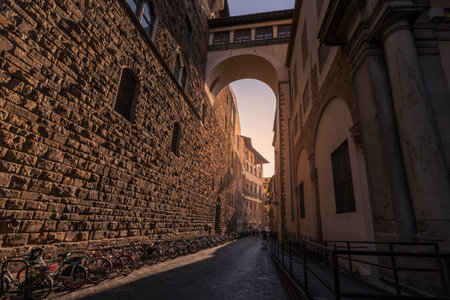 Narrow medieval street between ancient buildings made of rough stone blocks, Florence, Italyの写真素材