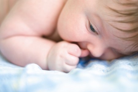 a new born boy lying on the nappies